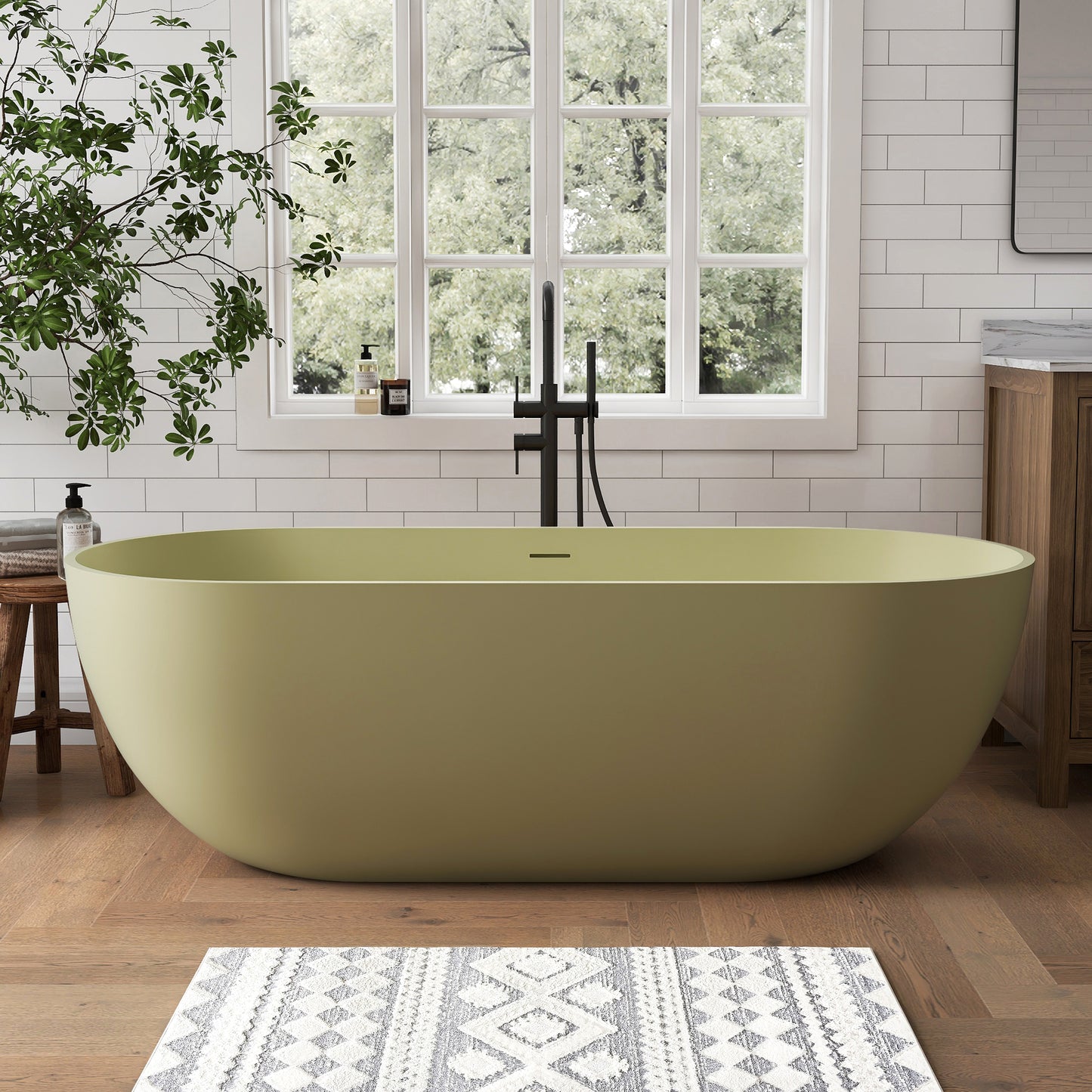 Green oval freestanding bathtub in a modern bathroom with a large window and plants.
