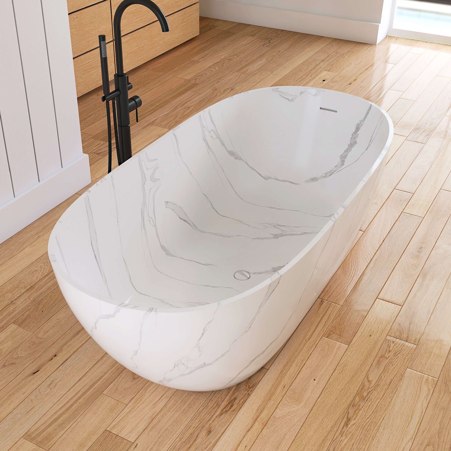 Marble-patterned freestanding bathtub on a wooden floor