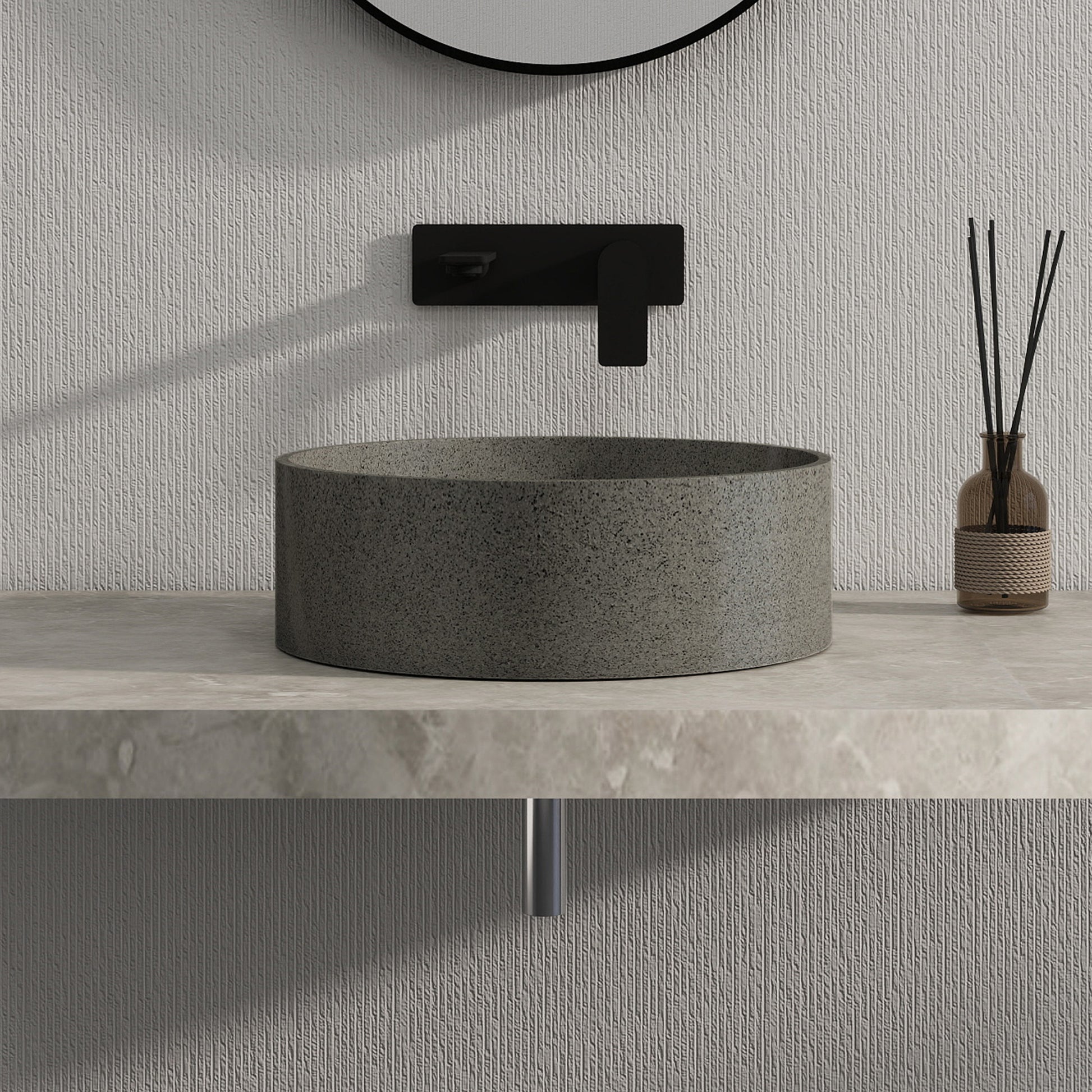Dark gray solid surface stone sink with black faucet and decorative vase on a light gray countertop.