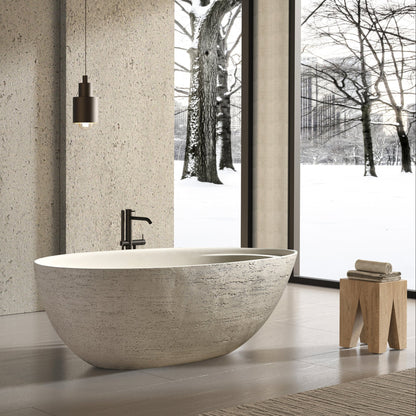 Modern bathroom with stone-look freestanding bathtub and sinks.