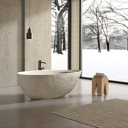 Modern bathroom with stone-look freestanding bathtub and sinks.
