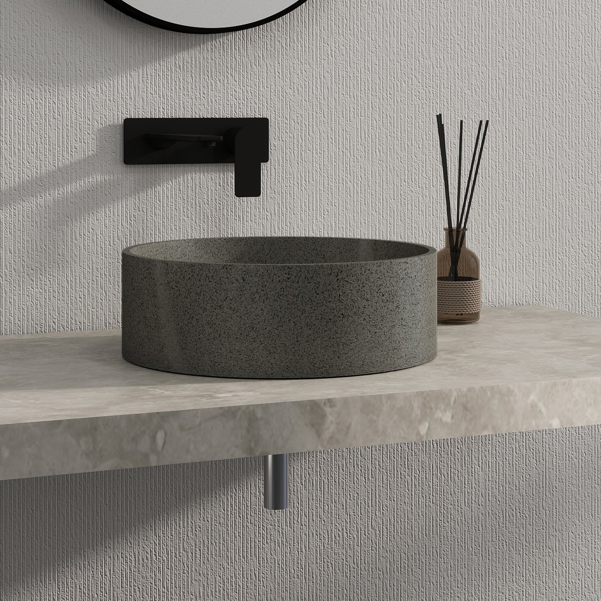 Dark gray solid surface stone sink on a light gray countertop with a textured wall background