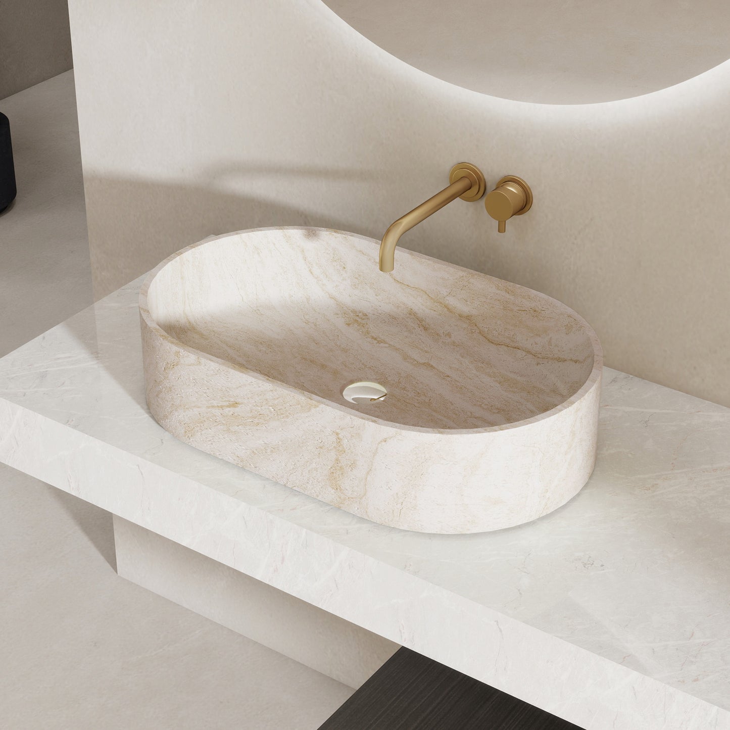 Marble pattern oval solid surface sink on a white countertop with a gold faucet.