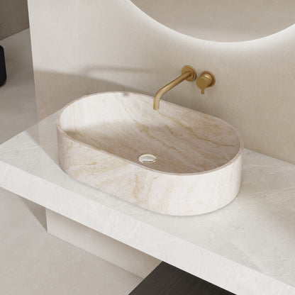 Marble pattern oval solid surface sink on a white countertop with a gold faucet.