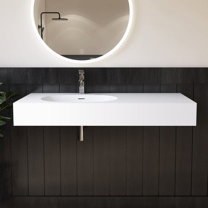 Modern bathroom vanity with white sink and illuminated mirror against a dark wooden wall.