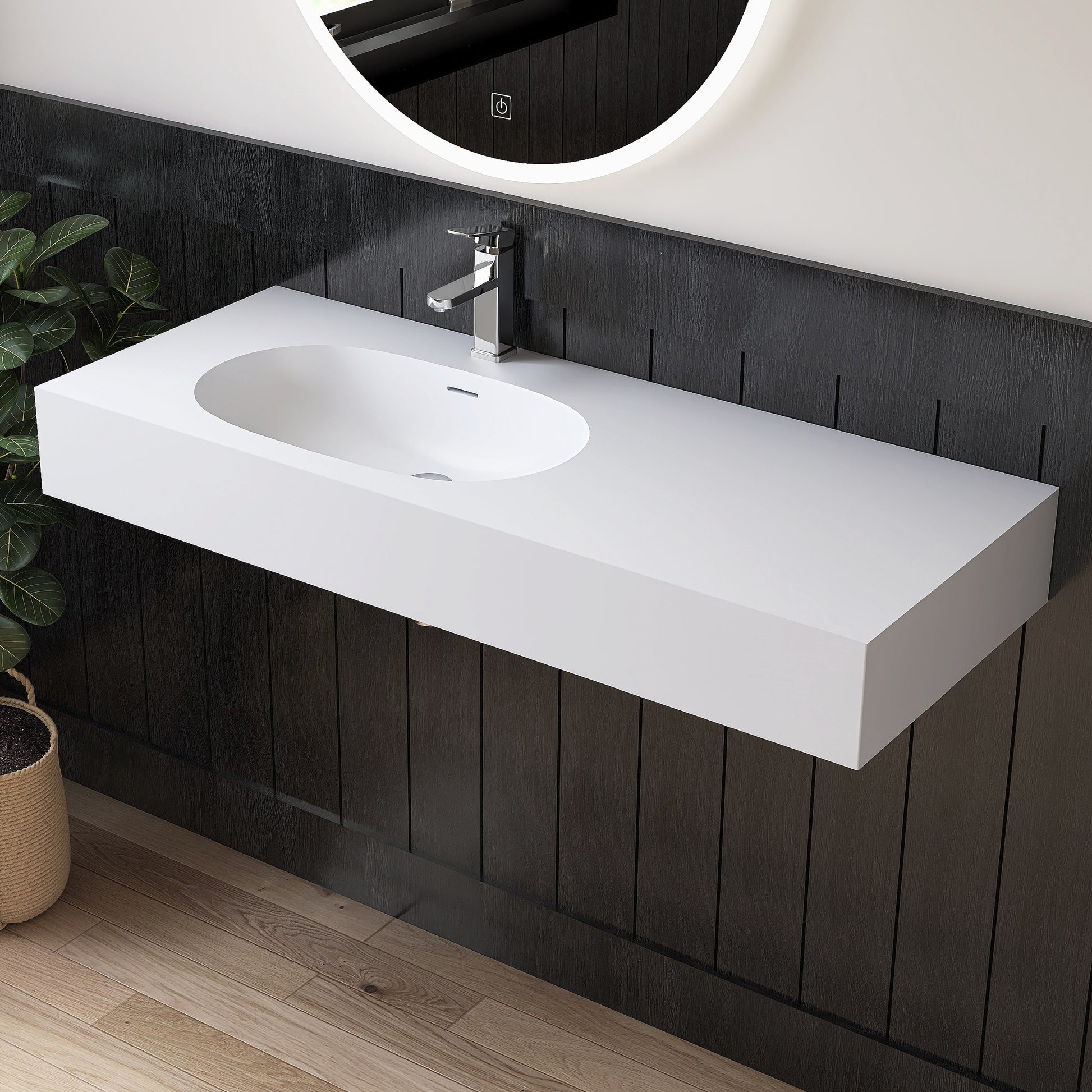 Bathroom vanity with white sink and black paneling