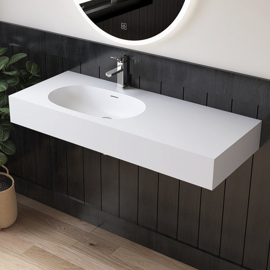 Bathroom vanity with white sink and black paneling