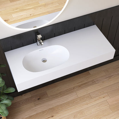 Bathroom vanity with white sink and dark wood cabinets on a wooden floor.