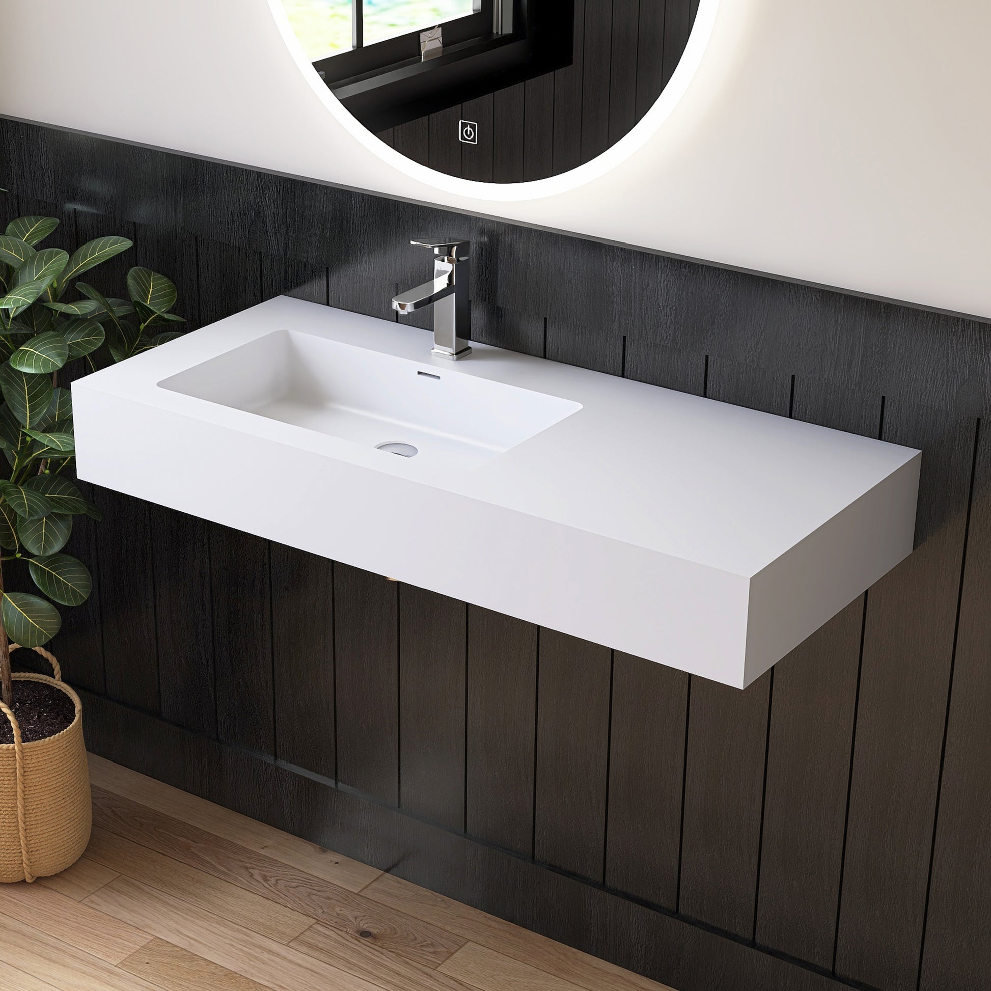 Modern bathroom vanity with white sink and dark wooden wall.