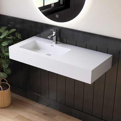 Modern bathroom vanity with white sink and dark wooden wall.