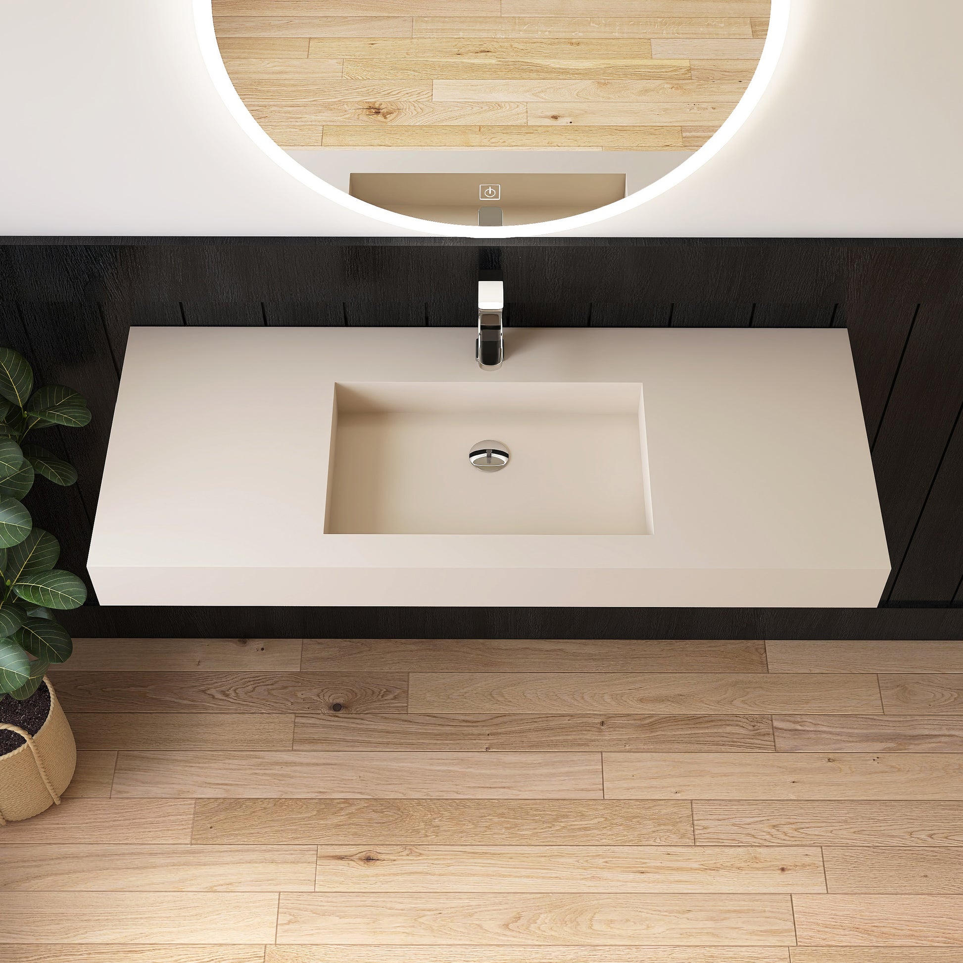 Bathroom vanity with wall mounted creamy beige sink and mirror on a wooden floor