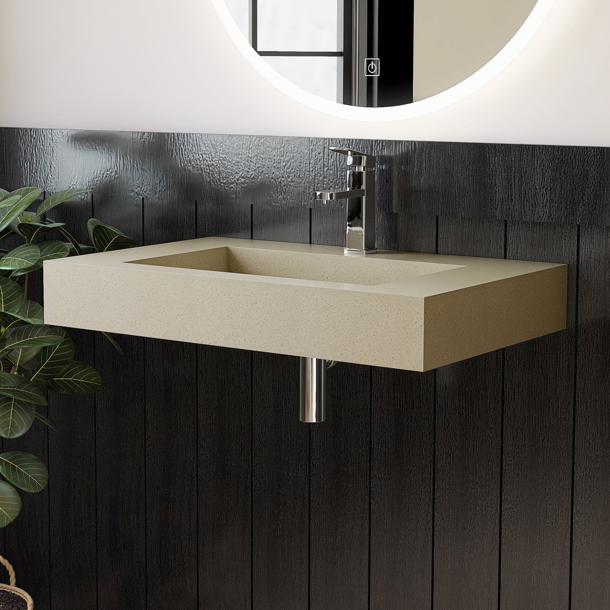 Beige wall-mounted sink with chrome faucet against a dark wooden panel wall.