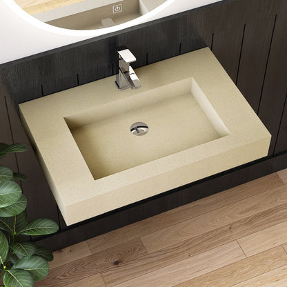 Beige wall mounted sink on a dark wooden vanity with a silver faucet
