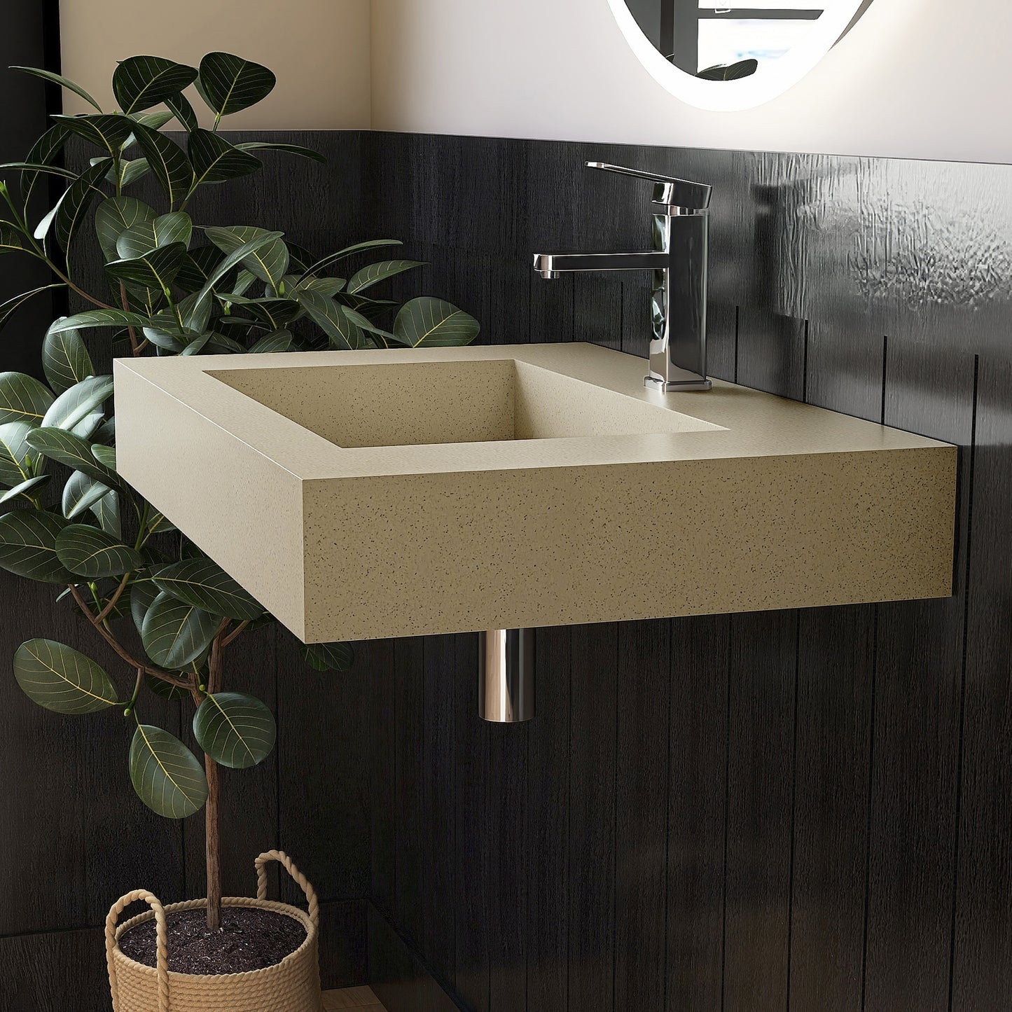 Beige wall mounted Bathroom sink with dark tiled wall and plant