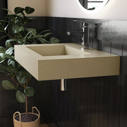 Beige wall mounted Bathroom sink with dark tiled wall and plant