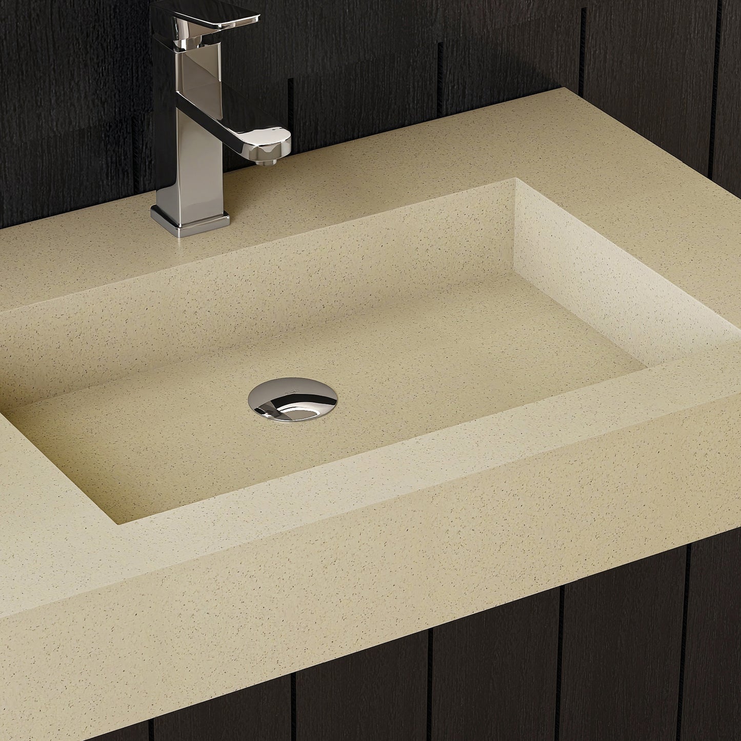 Beige countertop with a rectangular wall mounted sink and chrome faucet against a dark wooden panel background.