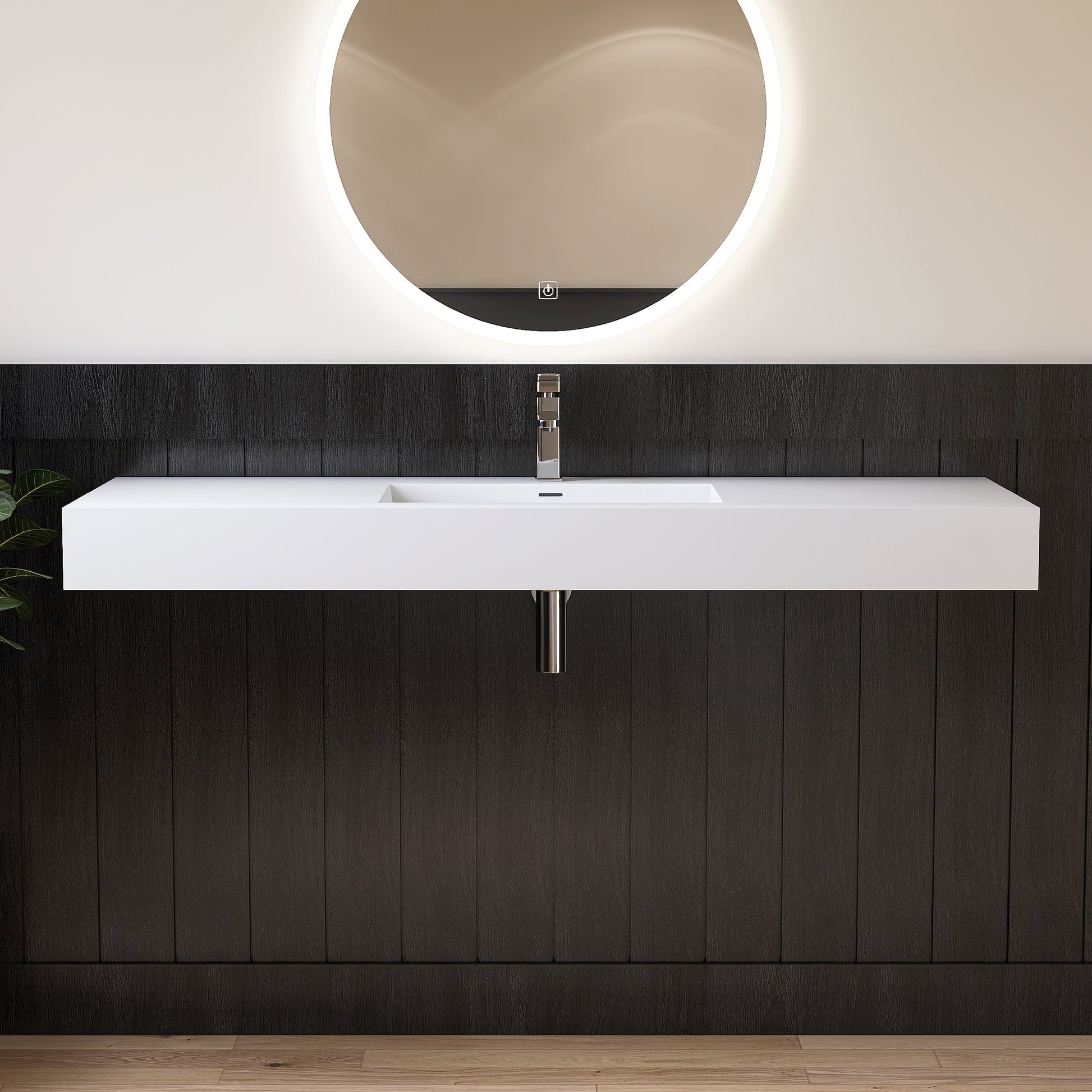 Bathroom vanity with white sink, dark wood paneling, and round mirror.