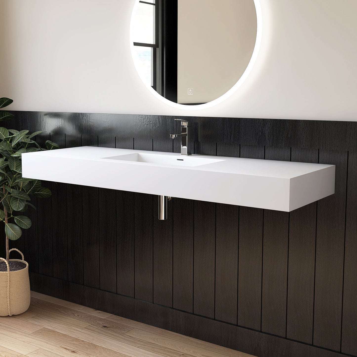 Modern bathroom with a white wall-mounted sink against a black paneled wall.