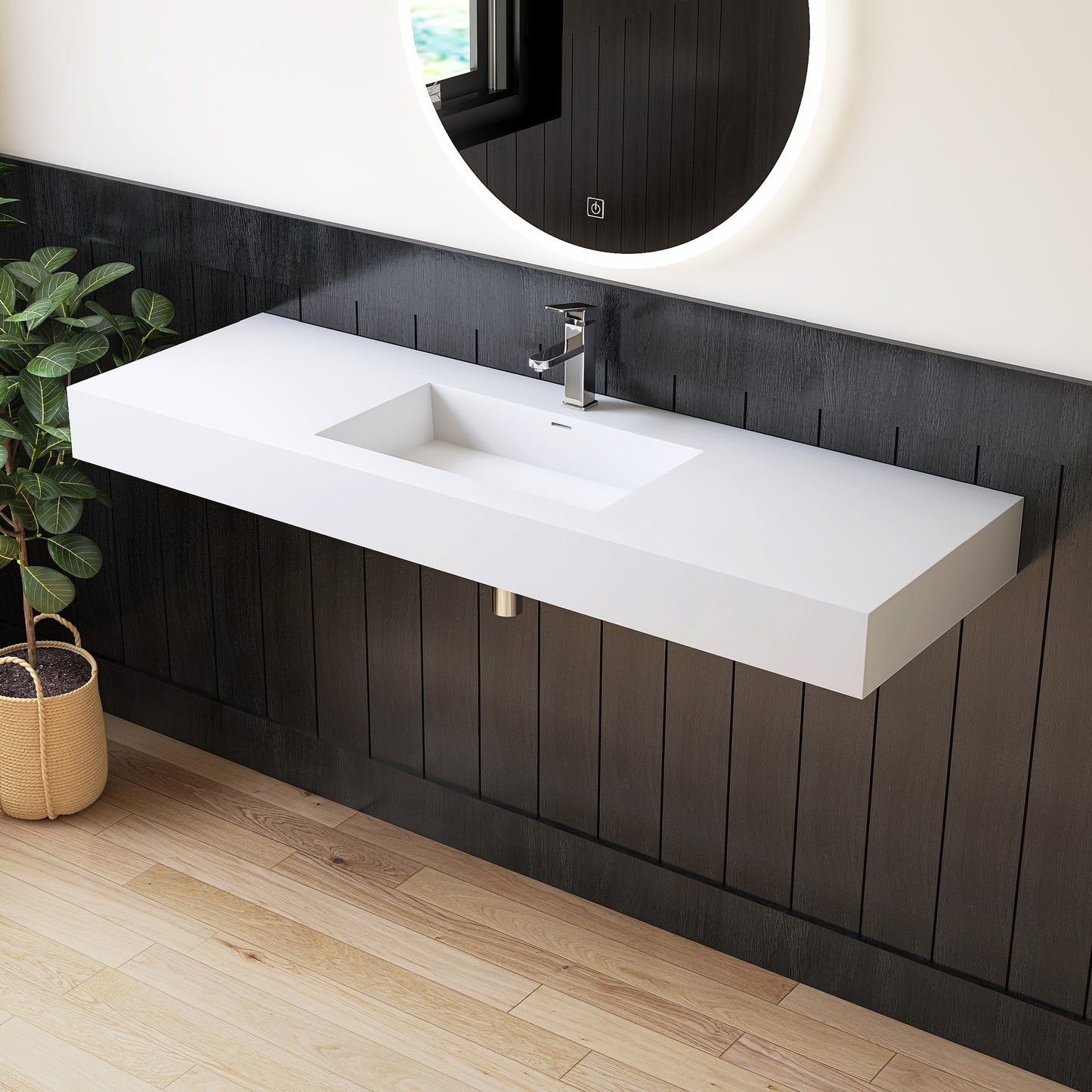 Modern bathroom with a long white sink against a dark wooden wall.