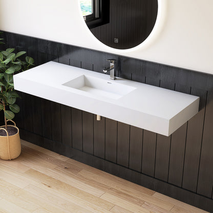Modern bathroom with a long white sink against a dark wooden wall.