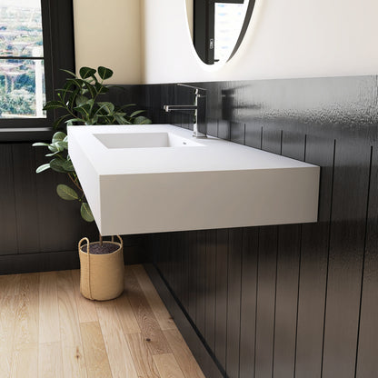 Modern bathroom with a white wall-mounted sink against a dark wooden wall.