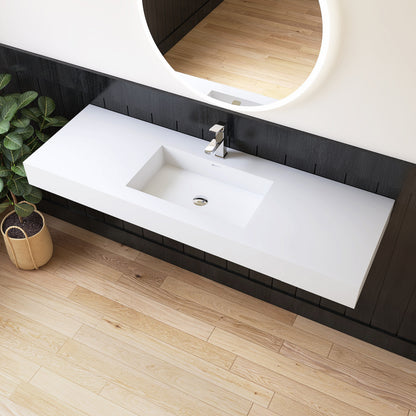 Modern bathroom vanity with white sink and round mirror on a wooden floor.