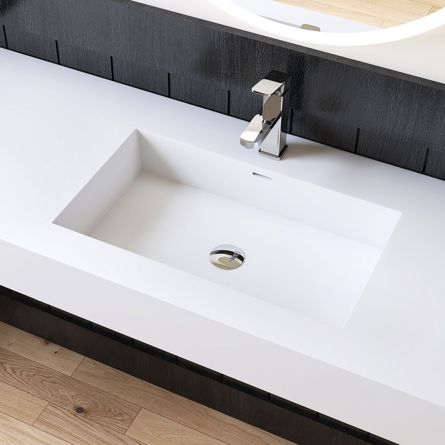 Modern white bathroom sink with chrome faucet against a black wall.