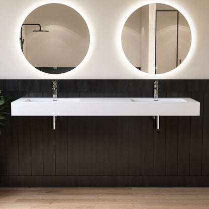 Modern bathroom vanity with two round mirrors and a double wall-mounted sink.
