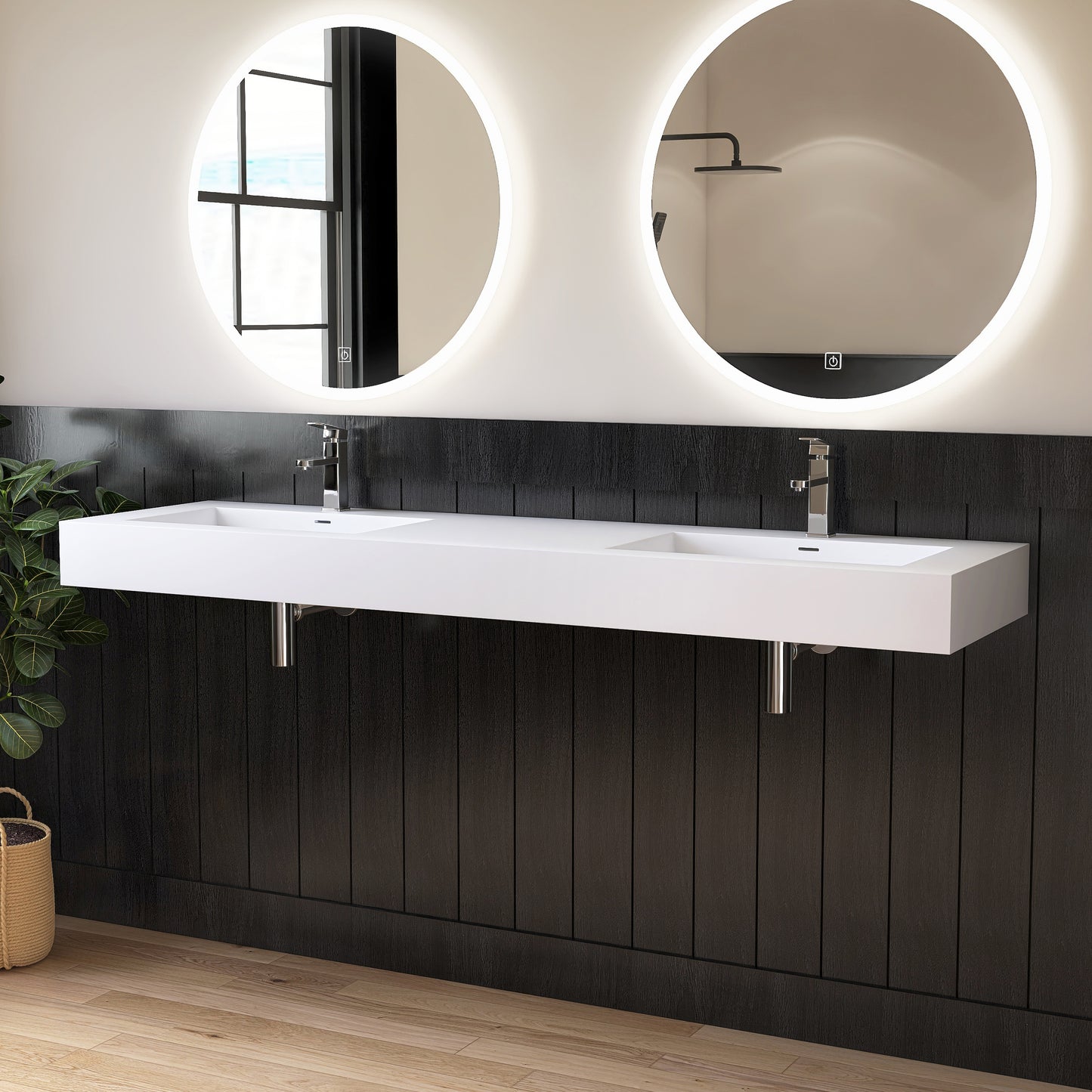 Bathroom with a white double wall-mounted sink, black wall panels, and round illuminated mirrors.