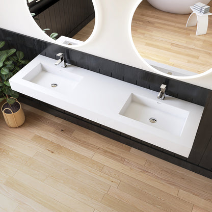 Bathroom with a long white double wall-mounted sink vanity against a black wall.