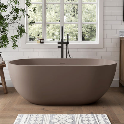 Grey-Coffee freestanding bathtub in a bathroom with a large window and plants.