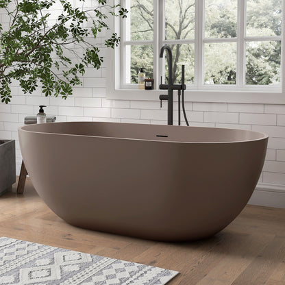 Grey-Coffee freestanding bathtub in a modern bathroom with a window and plant.