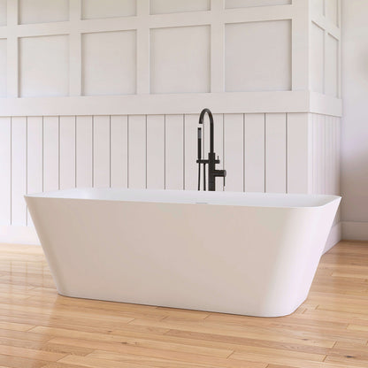 White freestanding bathtub with black faucet against a white paneled wall.