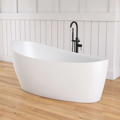 White freestanding bathtub on a wooden floor with a black faucet against a white paneled wall.