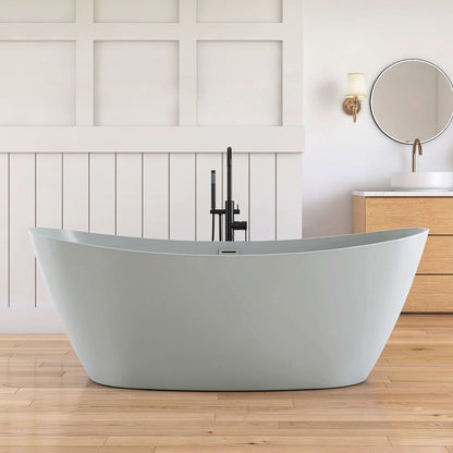 Modern freestanding bathtub in a bathroom with wooden flooring and white walls.