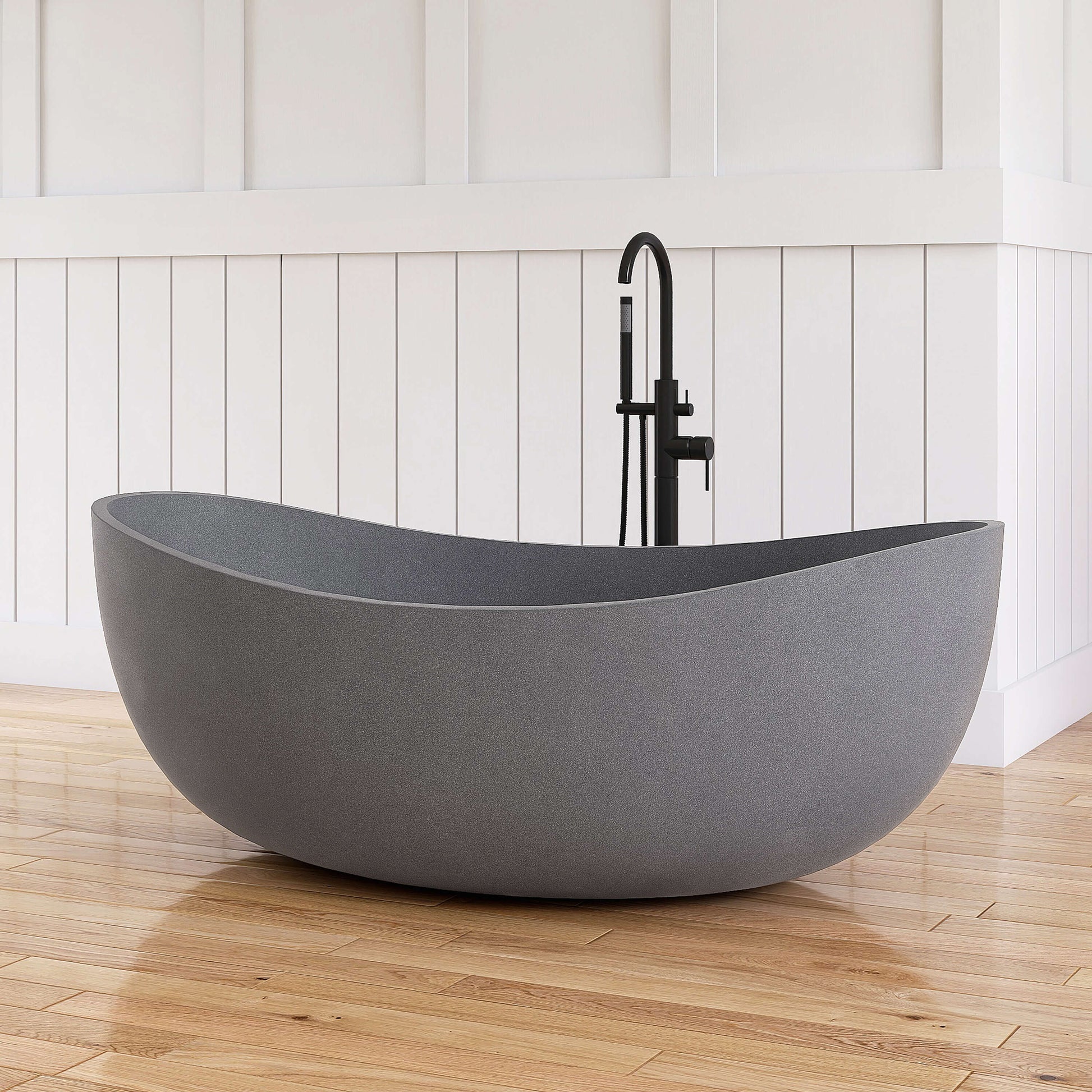 Gray freestanding bathtub with black faucet against a white paneled wall.