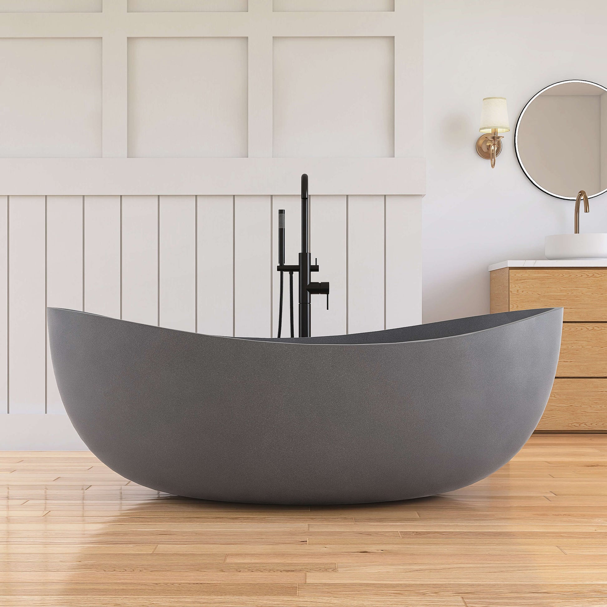 Gray freestanding bathtub in a modern bathroom with wooden floor and white walls.
