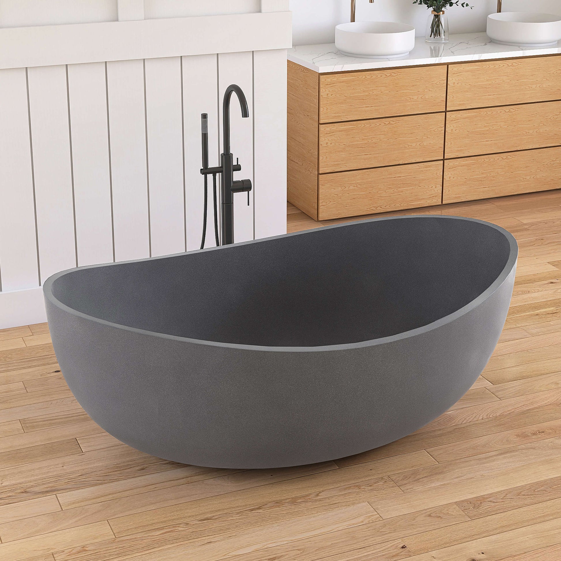 Gray freestanding bathtub in a modern bathroom with wooden cabinets and a white wall.