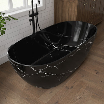 Black marble-patterned freestanding bathtub in a bathroom setting with wooden floor and white tiled wall.
