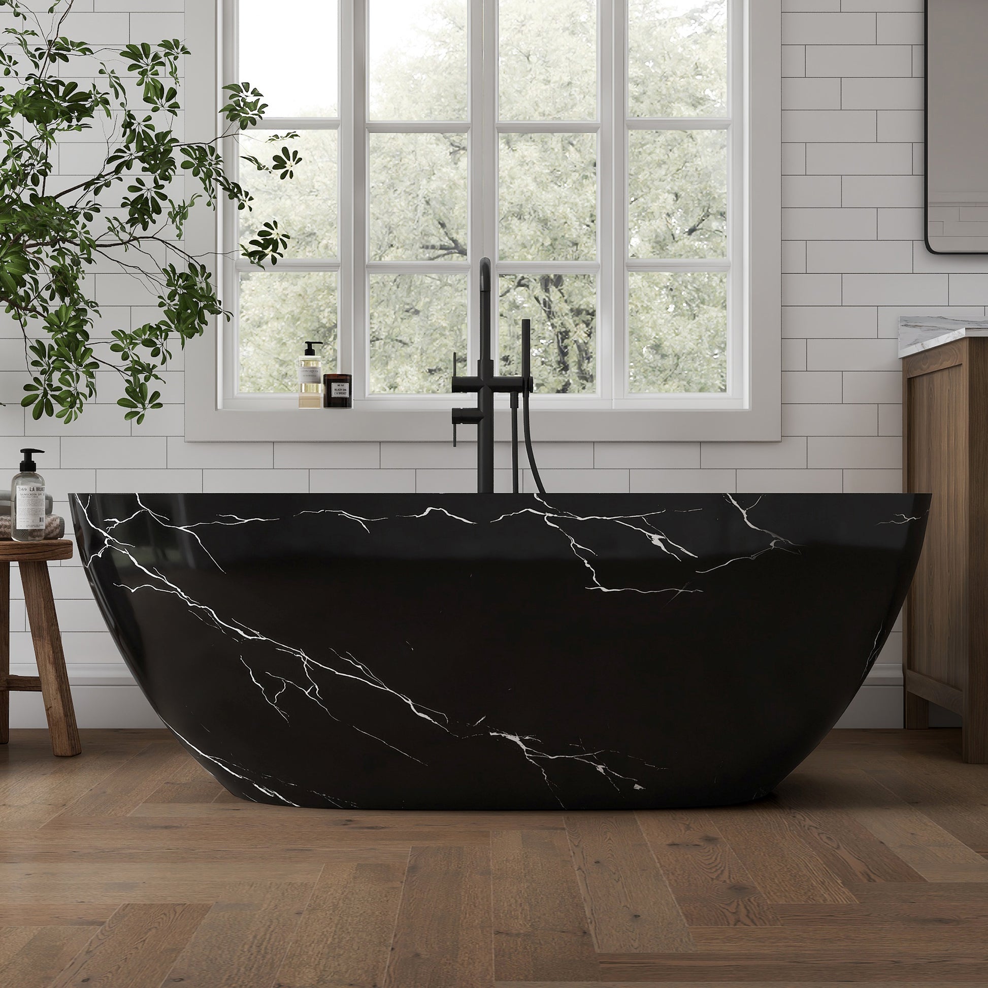 Black marble-patterned bathtub in a modern bathroom with large windows and wooden floor.