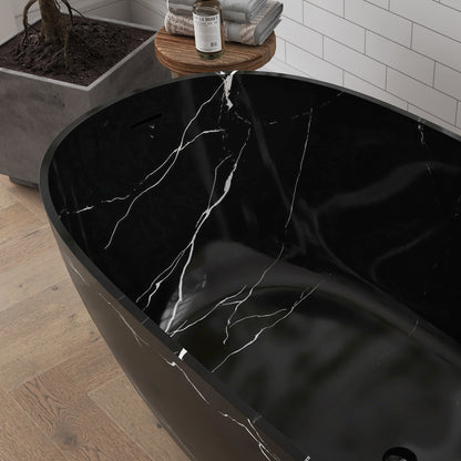 Black marble-patterned bathtub with water flowing into it in a bathroom setting.