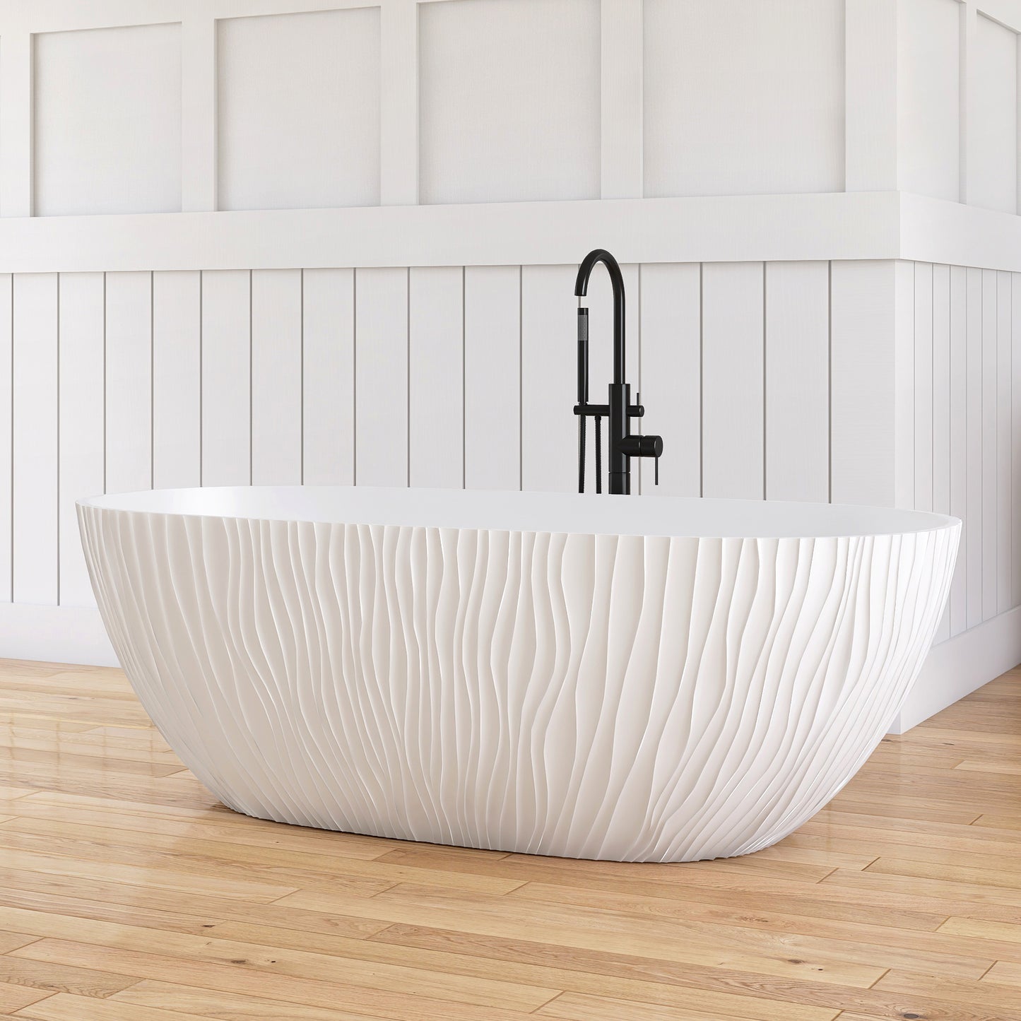 White freestanding bathtub with black faucet in a bathroom with wooden floor and white paneled walls.