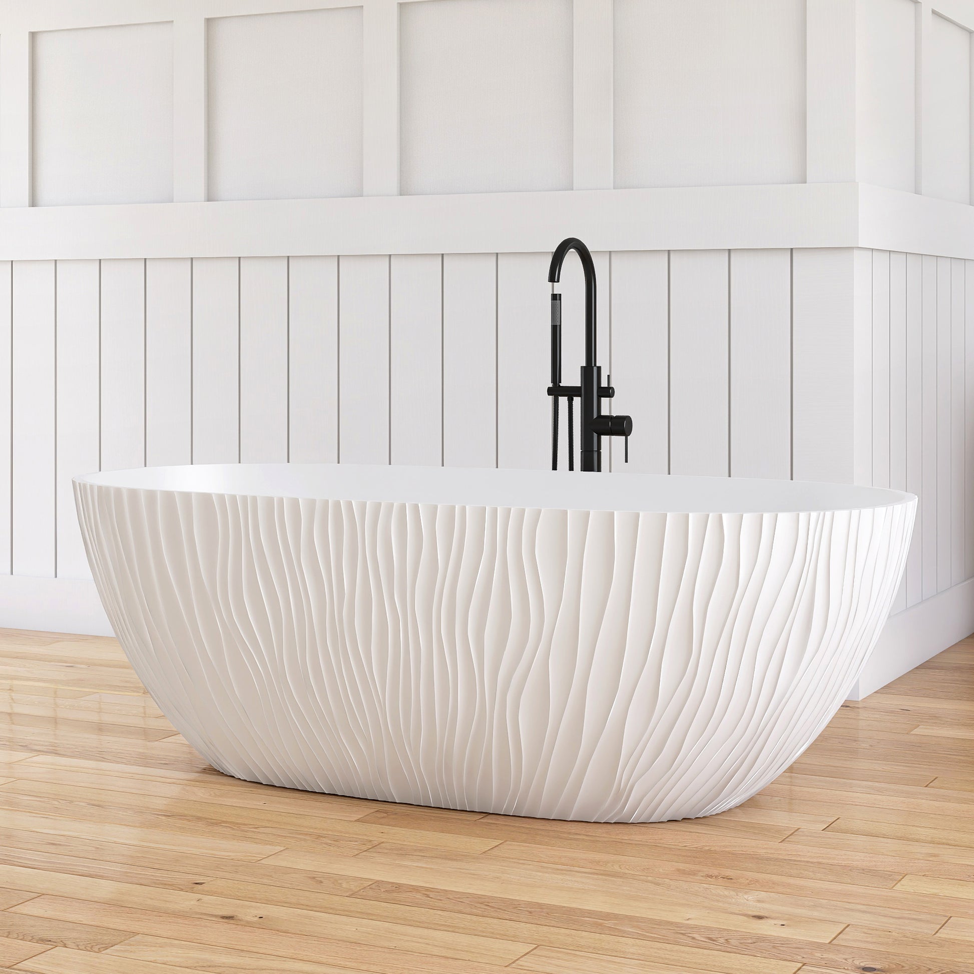 White freestanding bathtub with black faucet in a bathroom with wooden floor and white paneled walls.