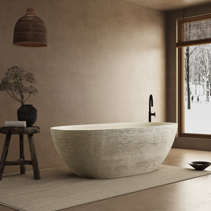 Modern bathroom with a freestanding bathtub, wooden stool, and window view of snow.