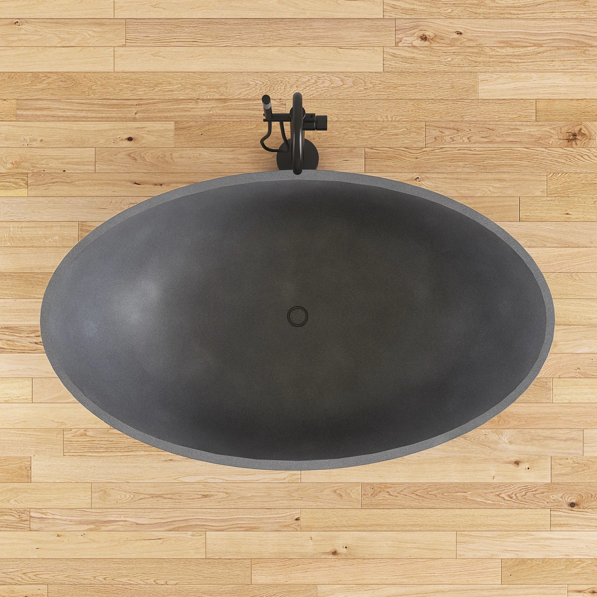 Black freestanding bathtub on a wooden floor